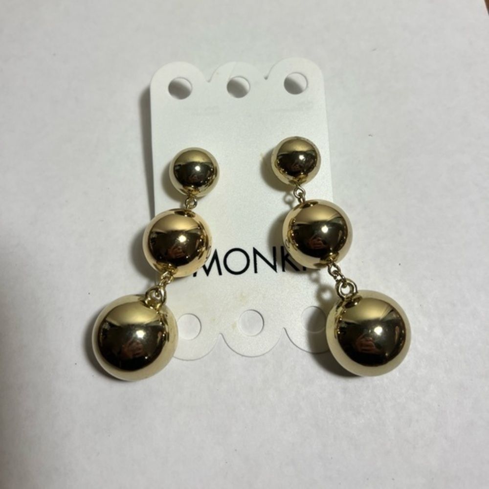 Three pairs of ball dangle statement earrings, gold and purple colors